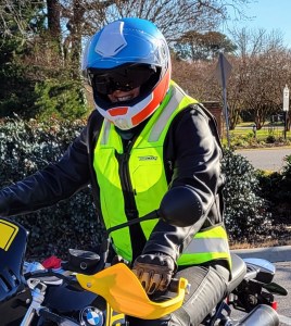 Author in helmet and Helite vest sitting on motorcycle.