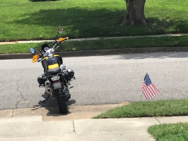 BMW R Nine T motorcycle with small USA flag in ground to the right.