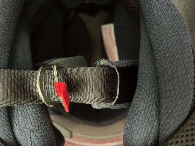 Chin strap of motorcycle helmet showing strap through the two rings.