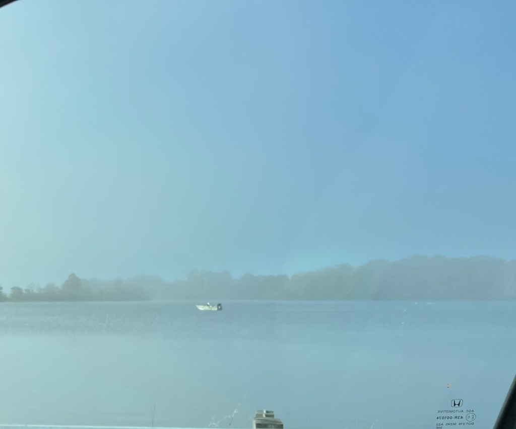 Haze over Lake Whitehurst and a happy boater enjoying the spring-like weather.