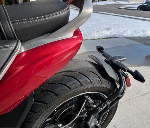 back tire of red motorcycle with snow
